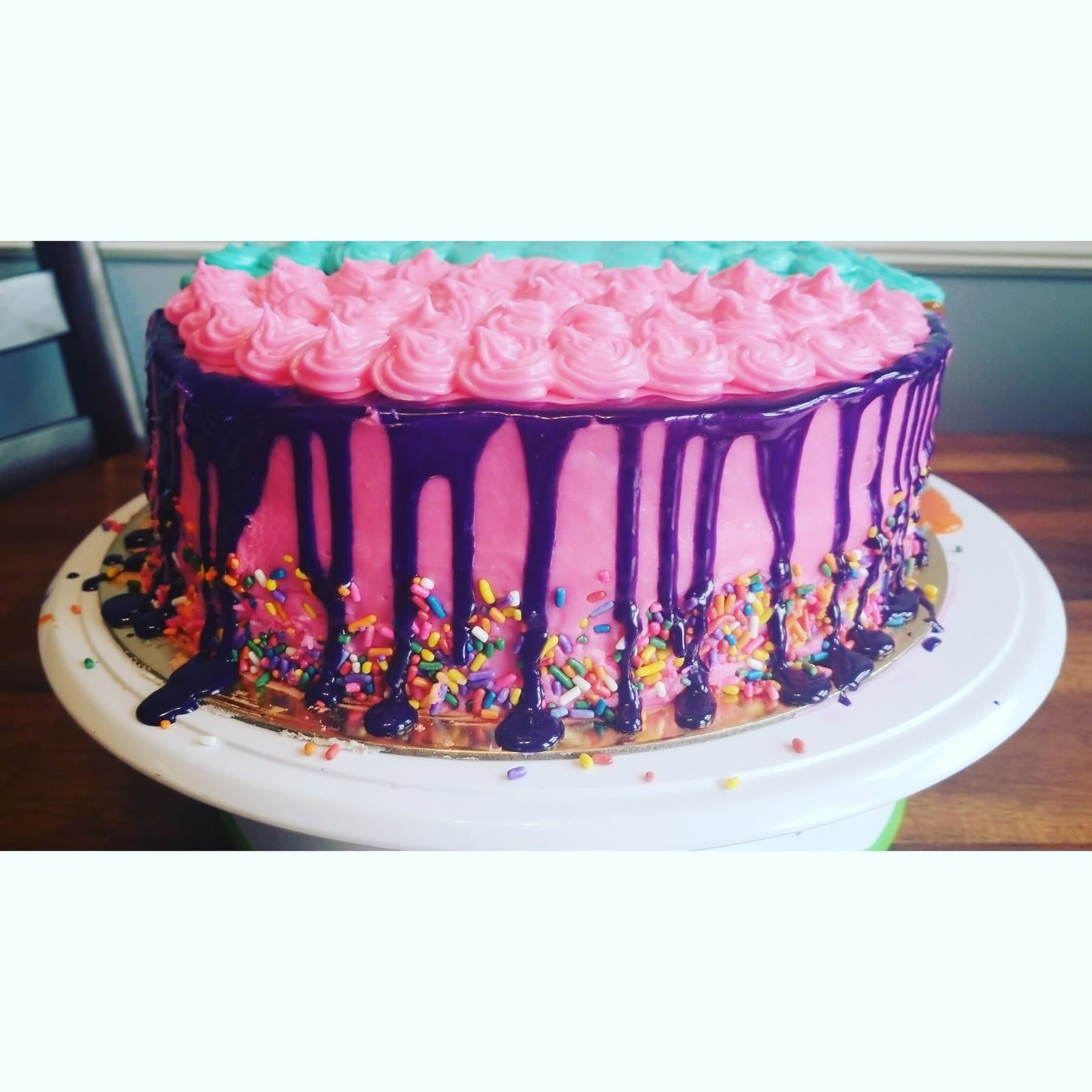 Pink and purple drip birthday cake with sprinkles and bold ganache by Jamie Cakes.