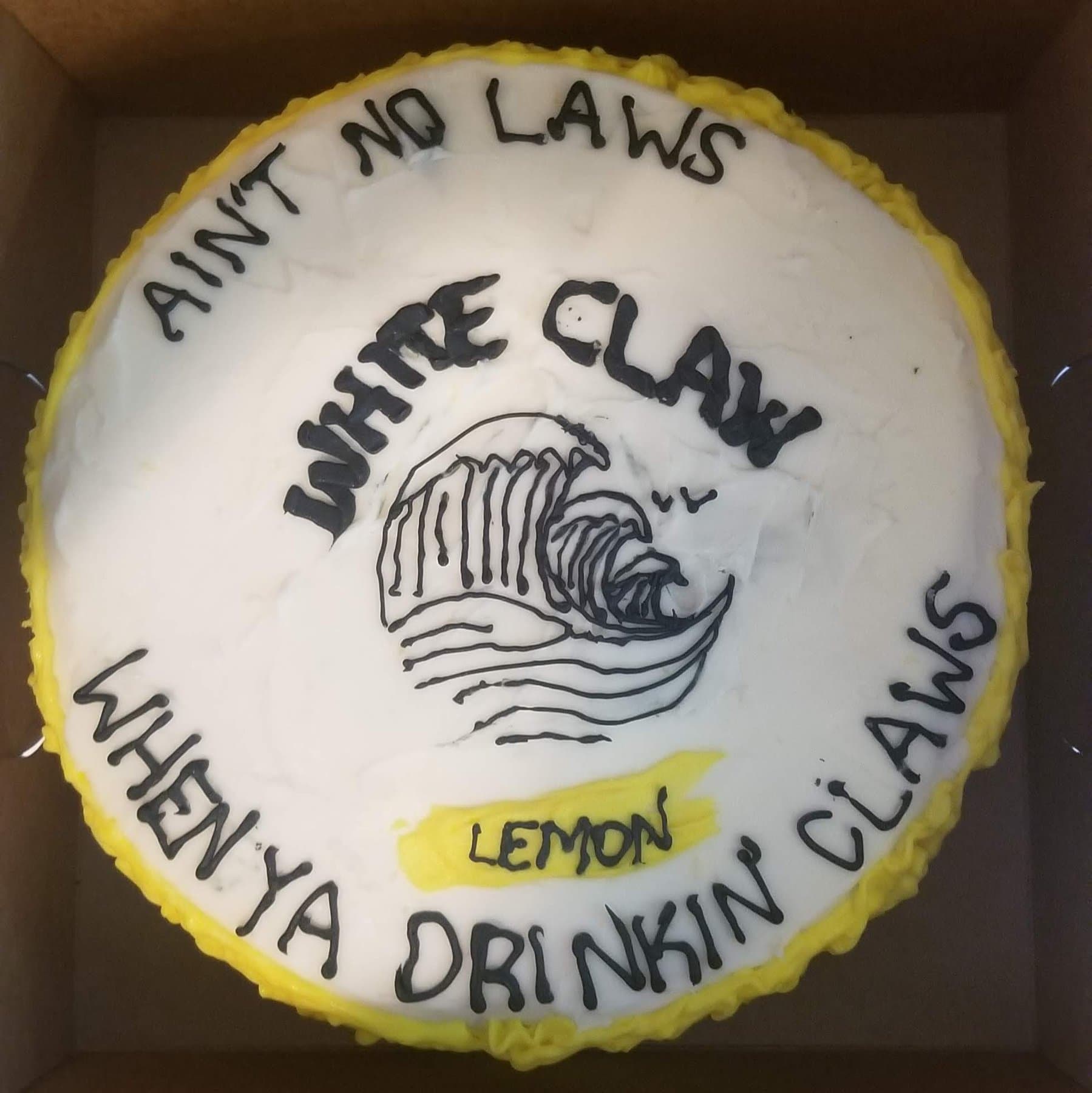 White Claw novelty cake with hand-piped lettering and lemon accent by Jamie Cakes.